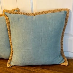 2 linen like pillows with woven jute around edges